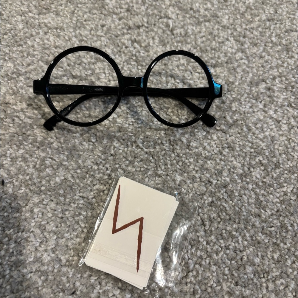 Harry Potter glasses and 9 scar tatoos.